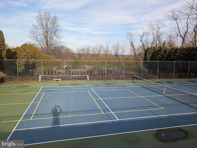 view of tennis court with fence