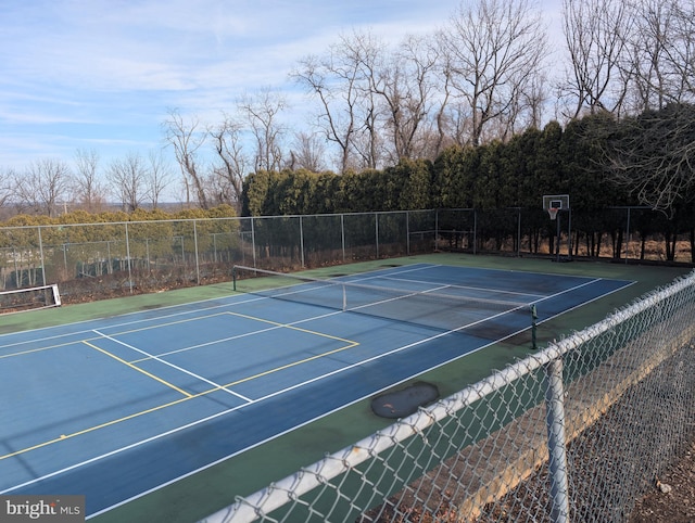 view of tennis court featuring fence