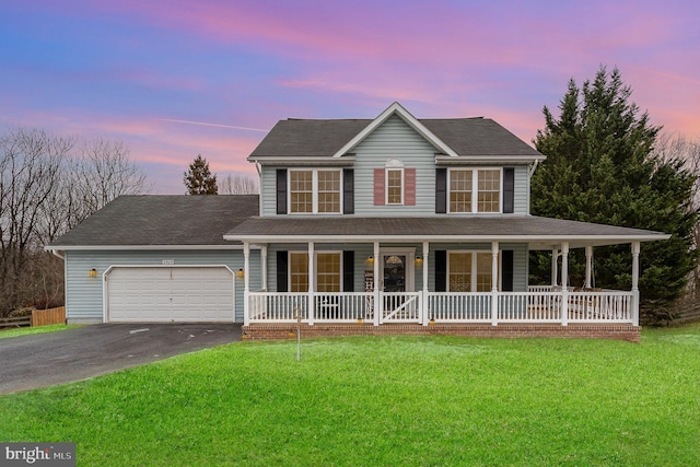 view of front of home featuring a porch, a garage, and a lawn