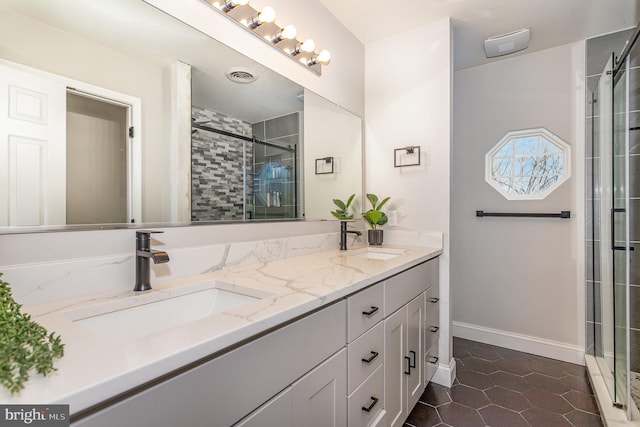 bathroom featuring tile patterned floors, vanity, and an enclosed shower