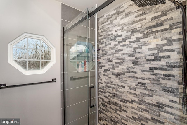 bathroom featuring a shower with shower door