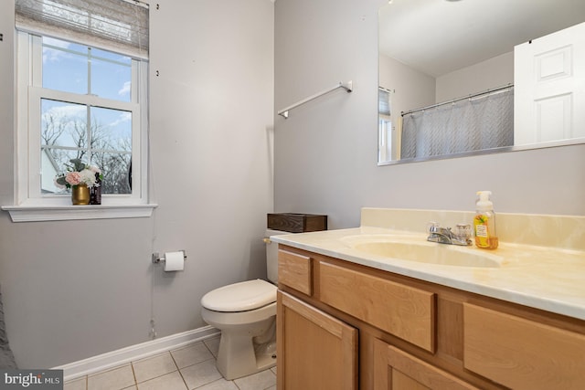 bathroom featuring vanity, toilet, and tile patterned flooring