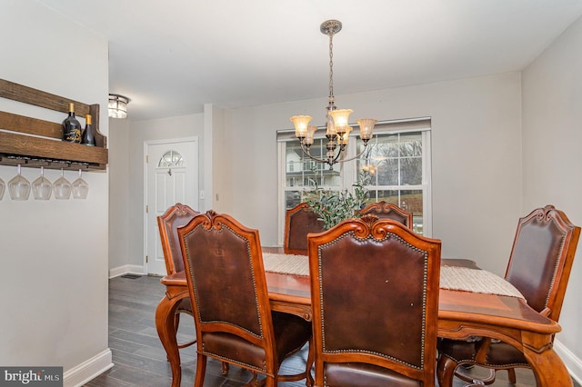 dining room featuring dark hardwood / wood-style floors and a notable chandelier