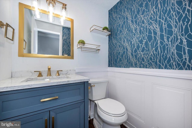 bathroom featuring vanity and toilet