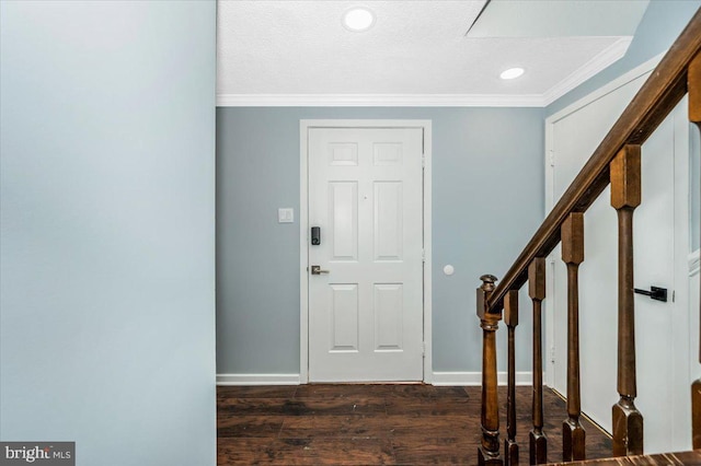 entrance foyer with ornamental molding, dark hardwood / wood-style floors, and a textured ceiling