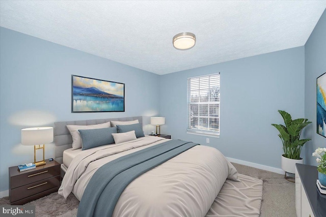 carpeted bedroom featuring a textured ceiling