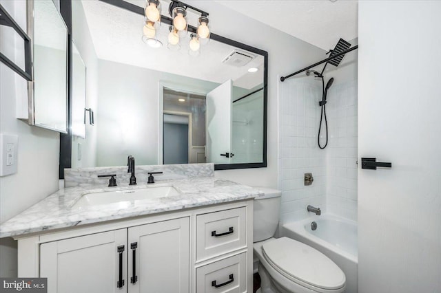 full bathroom with vanity, tiled shower / bath combo, and toilet