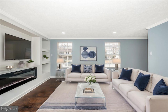 living room featuring a wealth of natural light, dark wood-type flooring, a textured ceiling, and built in shelves