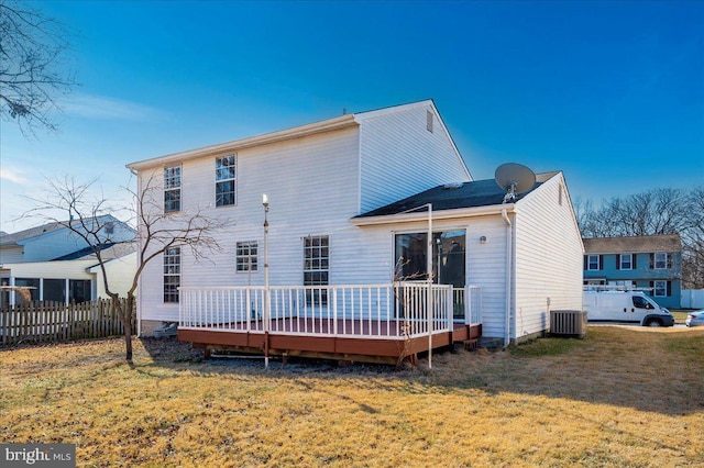 rear view of house featuring a yard, central air condition unit, and a deck