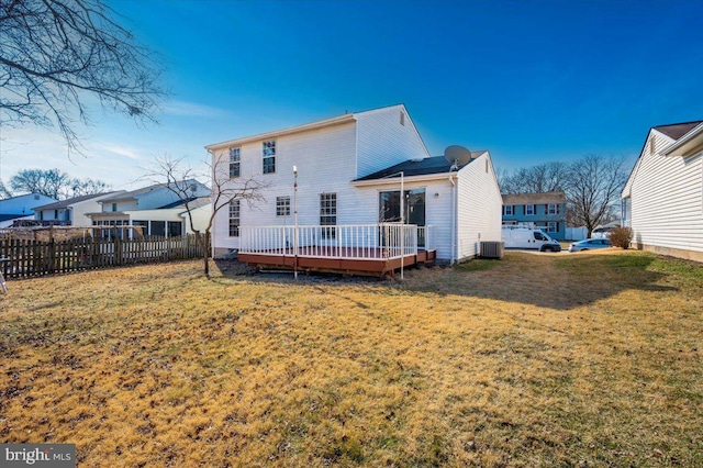 back of property with a yard, central AC, and a deck