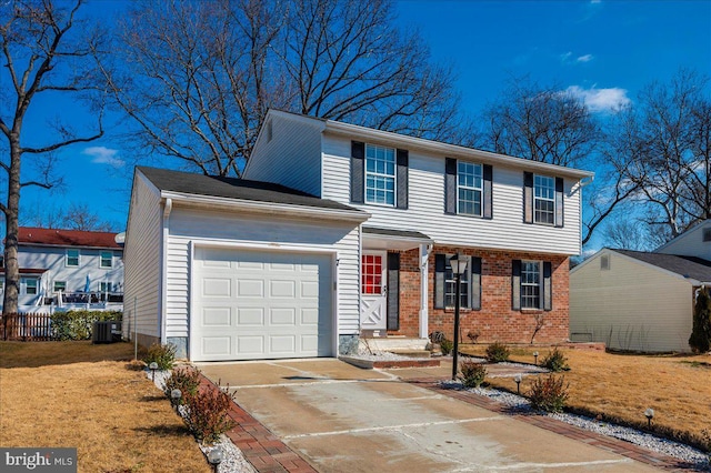 colonial inspired home featuring a garage and central air condition unit