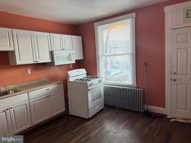 kitchen featuring white cabinetry, dark hardwood / wood-style flooring, white appliances, and radiator heating unit