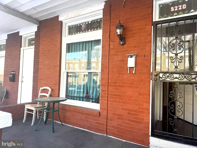 doorway to property featuring covered porch