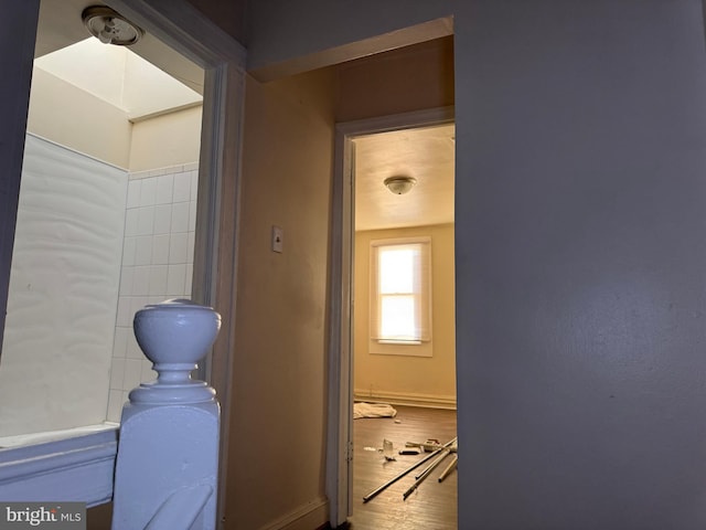 hallway with hardwood / wood-style flooring