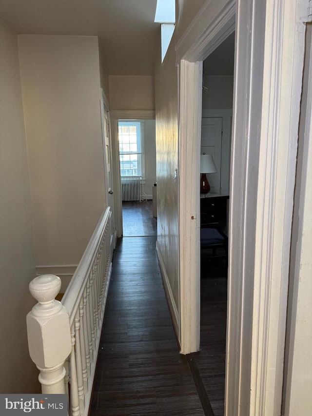 corridor with radiator and dark wood-type flooring