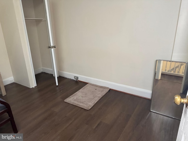 unfurnished bedroom with dark wood-type flooring