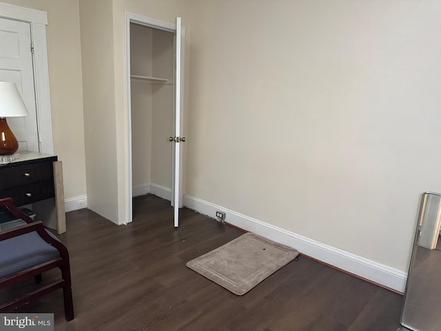 bedroom featuring a closet and dark hardwood / wood-style floors