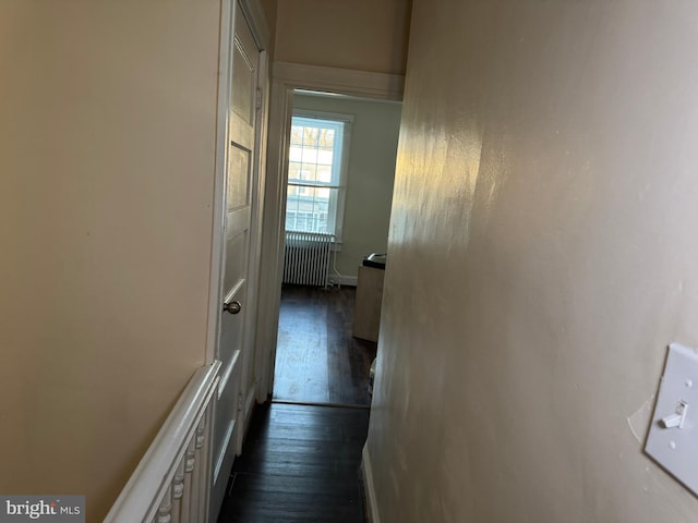 hall featuring radiator heating unit and dark hardwood / wood-style floors