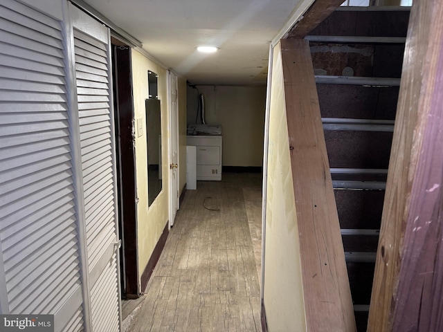 hall with hardwood / wood-style flooring and washing machine and clothes dryer