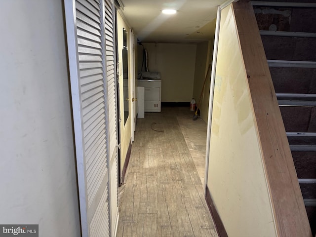 hallway featuring washer / dryer and light hardwood / wood-style floors