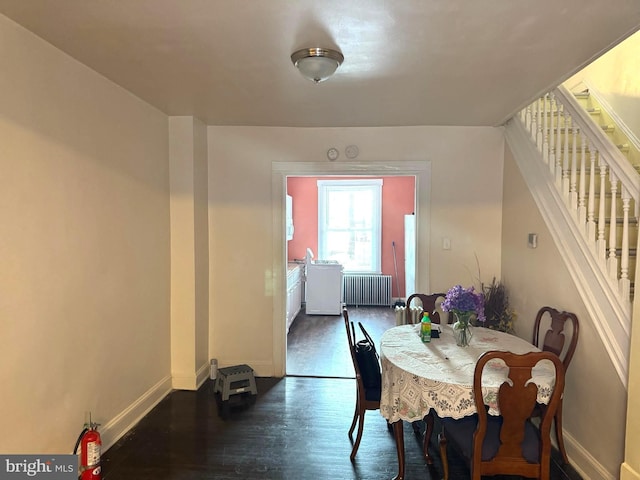 dining space featuring dark hardwood / wood-style flooring and radiator