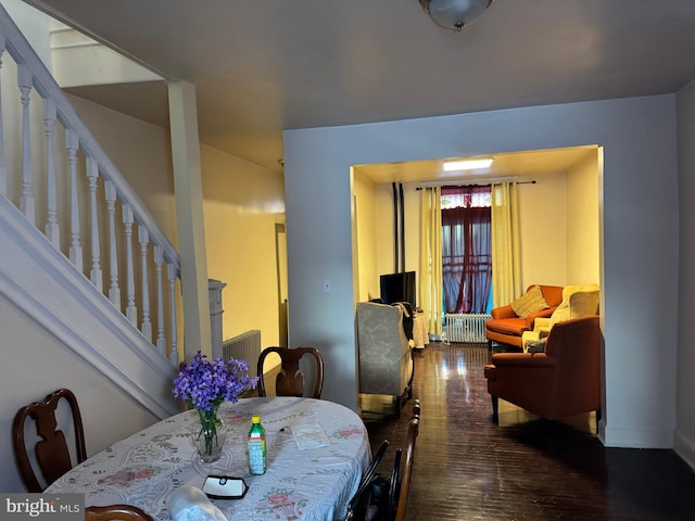 dining area featuring radiator and hardwood / wood-style floors