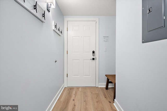 doorway featuring electric panel and light wood-type flooring