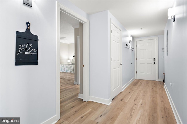 hall with light hardwood / wood-style flooring