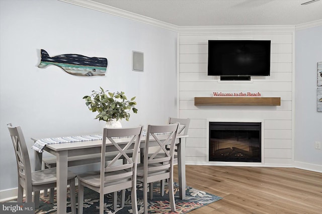 dining room with ornamental molding and hardwood / wood-style floors