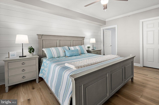 bedroom featuring crown molding, ceiling fan, and light wood-type flooring