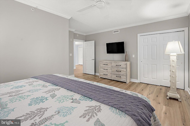 bedroom featuring ceiling fan, ornamental molding, and light hardwood / wood-style flooring