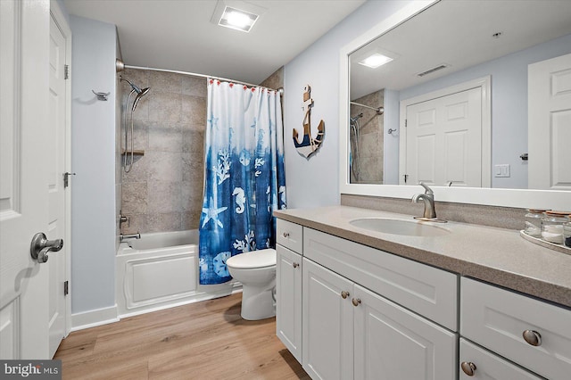 full bathroom featuring wood-type flooring, toilet, vanity, and shower / tub combo with curtain