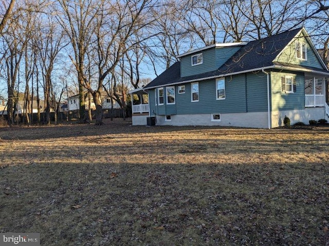 view of side of home with central AC