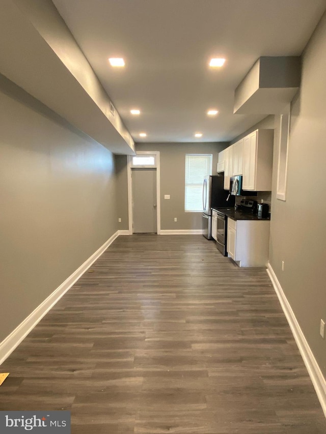 kitchen featuring white cabinetry, stainless steel appliances, and dark hardwood / wood-style floors