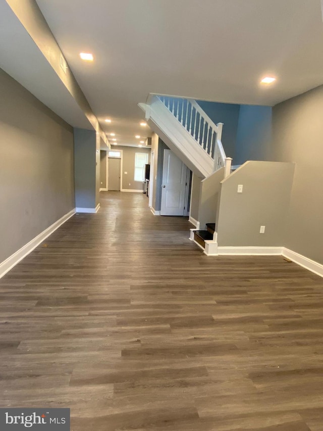 unfurnished living room with dark hardwood / wood-style flooring