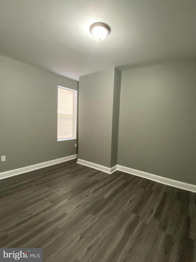 spare room featuring dark hardwood / wood-style floors