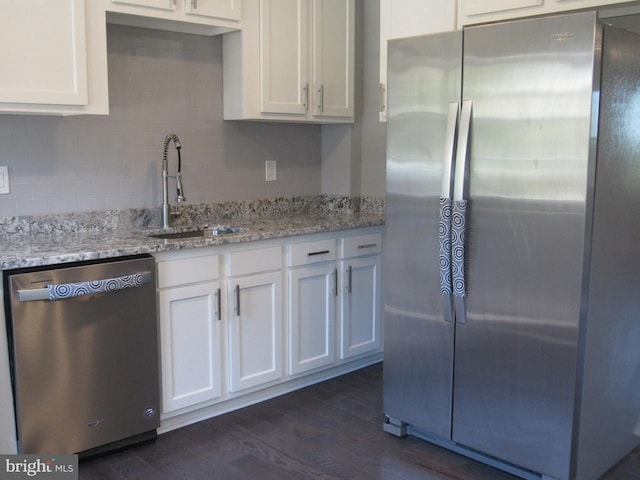 kitchen with appliances with stainless steel finishes, sink, and white cabinets