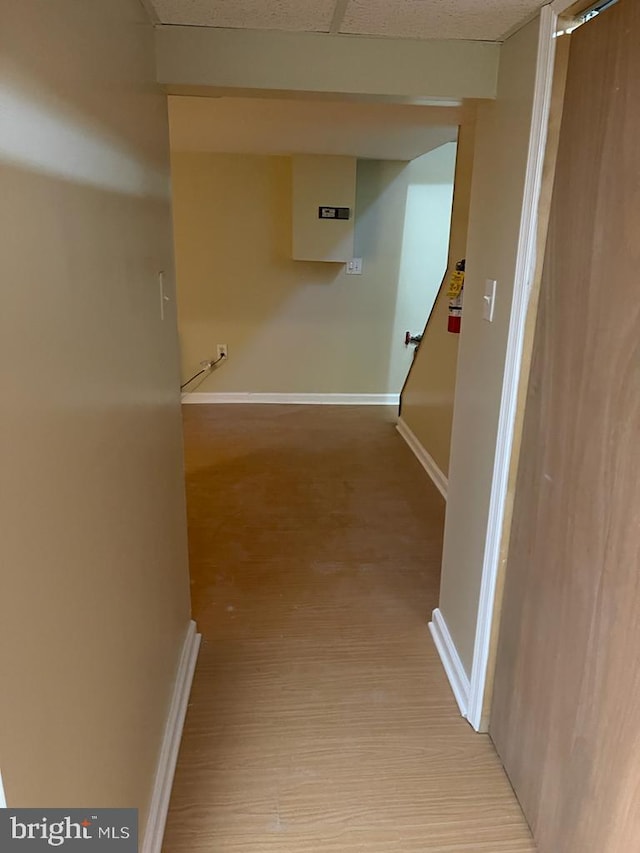 hallway with light hardwood / wood-style floors