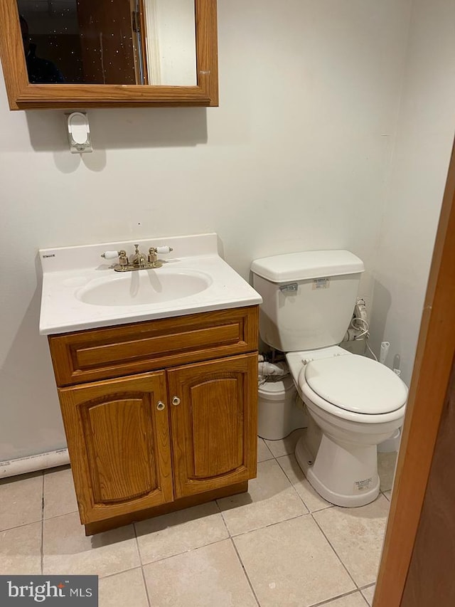 bathroom featuring tile patterned flooring, vanity, and toilet