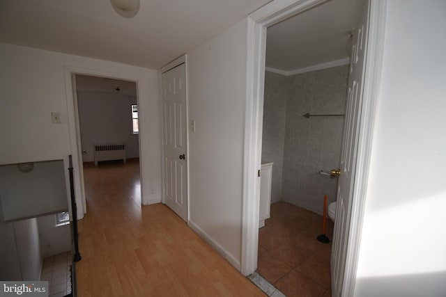 hall with radiator and light hardwood / wood-style flooring