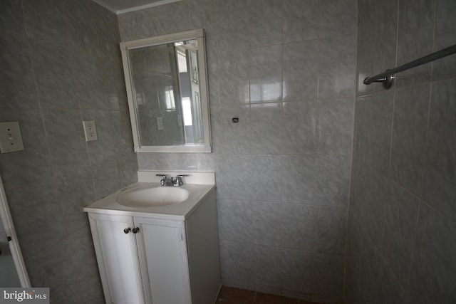 bathroom with vanity and tile walls