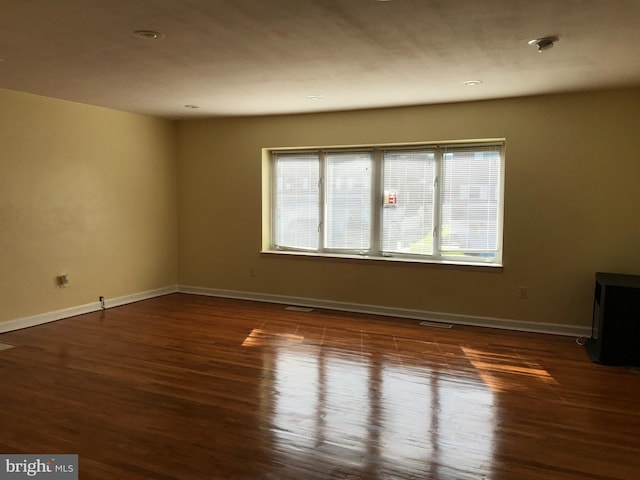 spare room featuring dark hardwood / wood-style floors