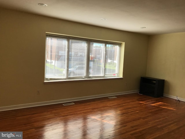 spare room featuring dark hardwood / wood-style flooring