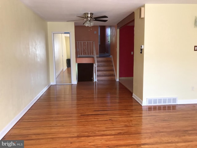 empty room featuring ceiling fan and hardwood / wood-style floors