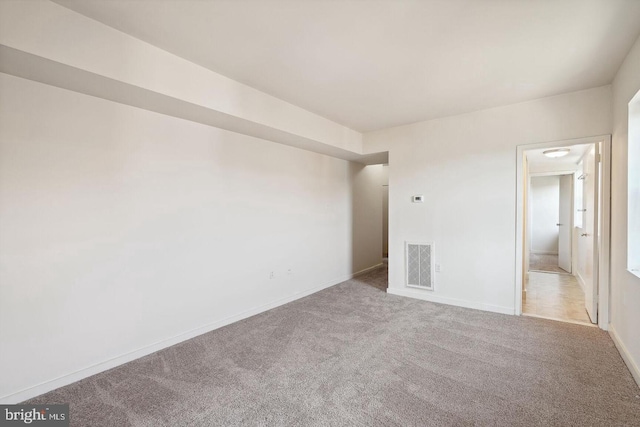 unfurnished bedroom with light colored carpet, visible vents, and baseboards