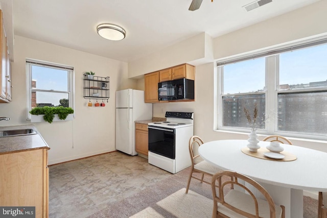 kitchen featuring ceiling fan, sink, and white appliances