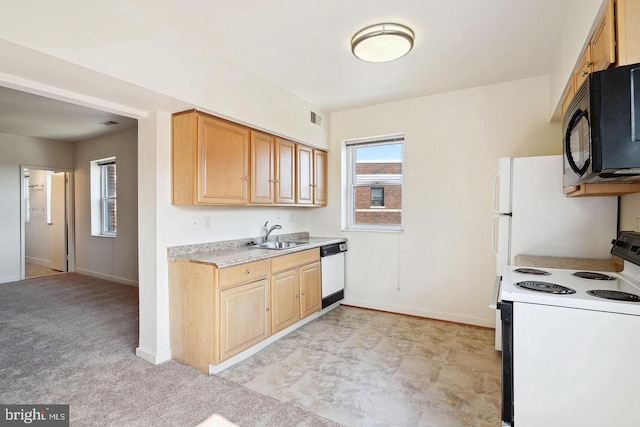 kitchen featuring black microwave, white dishwasher, a sink, light countertops, and electric range oven