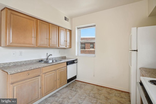 kitchen with white appliances, a sink, visible vents, baseboards, and light countertops