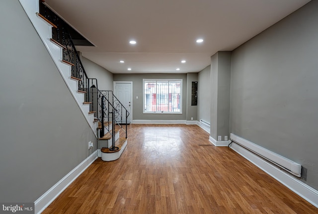 interior space with baseboard heating and light hardwood / wood-style flooring