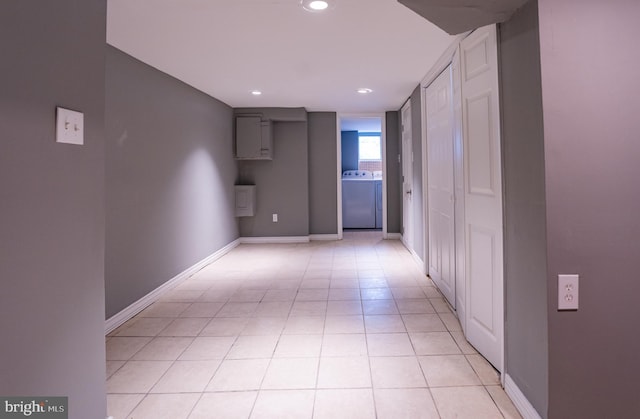 hall with light tile patterned flooring and washer / clothes dryer